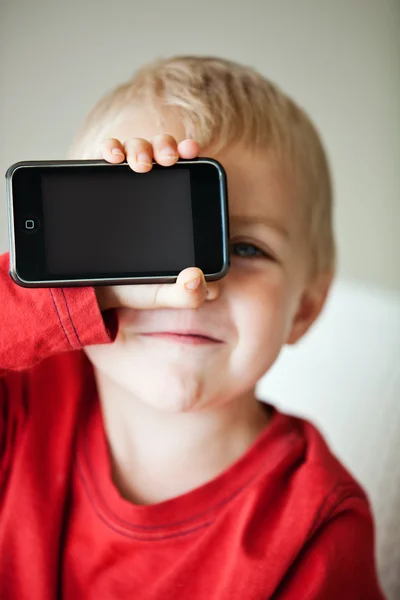 Small boy and media player — Stock Photo, Image