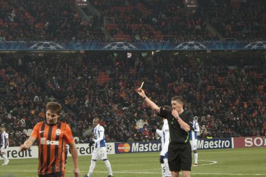 Referee Craig Thomson (SCO) shows a yellow card clipart