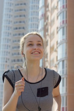 Young beautiful woman running in city street clipart