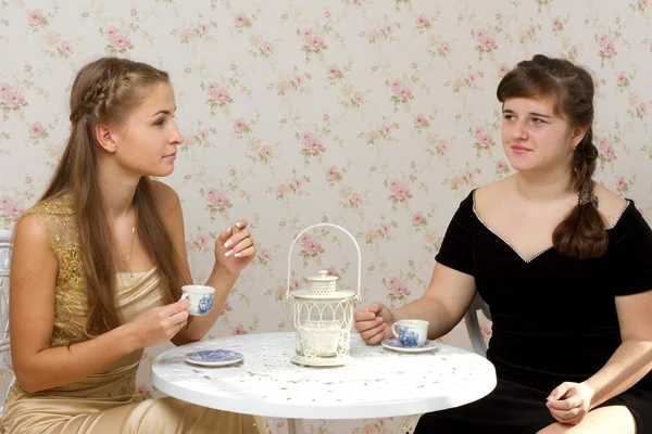 Iki kız bir kafede bir masada konuşurken — Stok fotoğraf