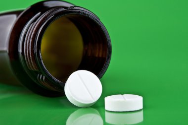 Two white pills with bottle clipart