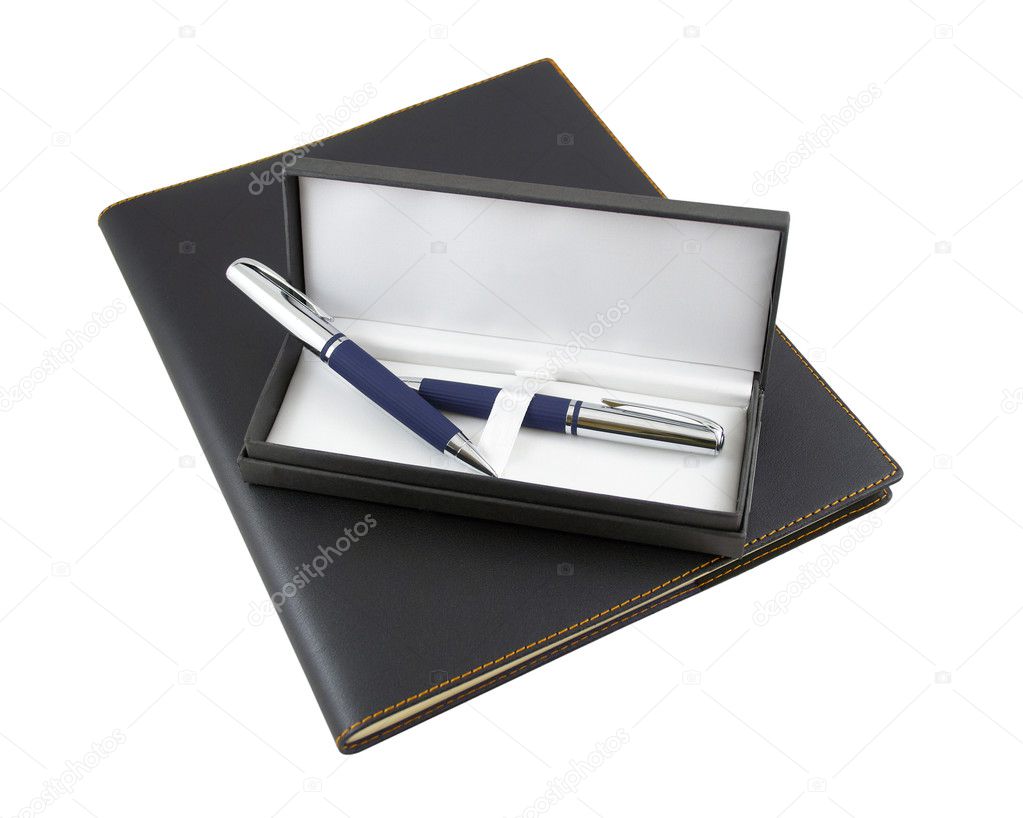 Pen and pencil in a gift box on top of black luxury organizer