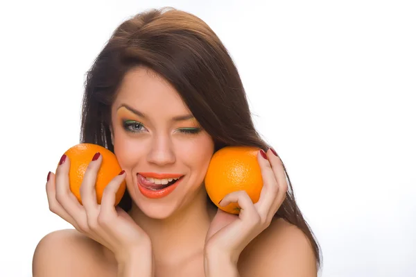 Flicka med apelsiner — Stockfoto