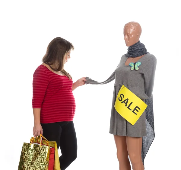 Nice pregnat woman choosing a dress — Stock Photo, Image