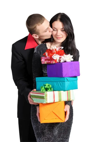 Boy kisses the girl, who is holding a box of gifts — Stock Photo, Image