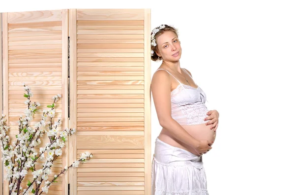 Velmi těhotná žena s květinami — Stock fotografie