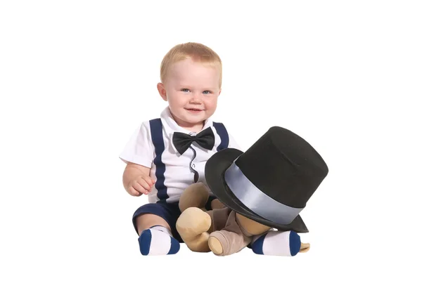 Baby boy magician hiding soft toy under cylinder — Stock Photo, Image