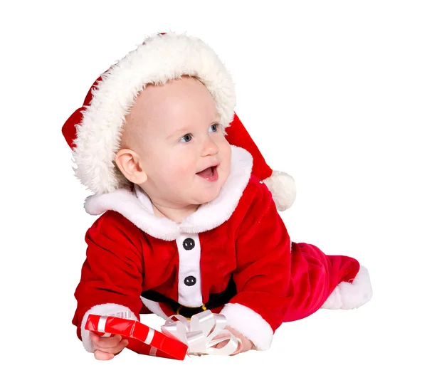 Menino vestindo o traje do Papai Noel sentado e segurando uma caixa com — Fotografia de Stock