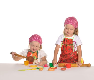 Two little housewifes in colourful aprons isolated on white back clipart