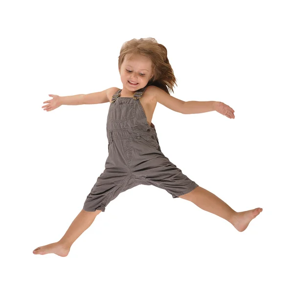 Ativo pulando menina em rompers isolado no fundo branco — Fotografia de Stock
