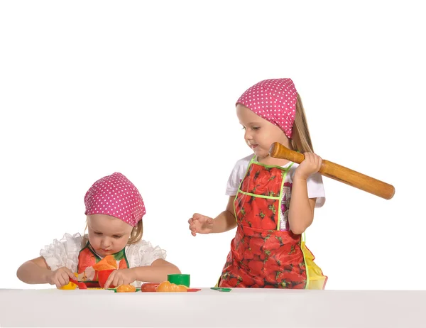 Two little housewifes in colourful aprons isolated on white back — Stock Photo, Image