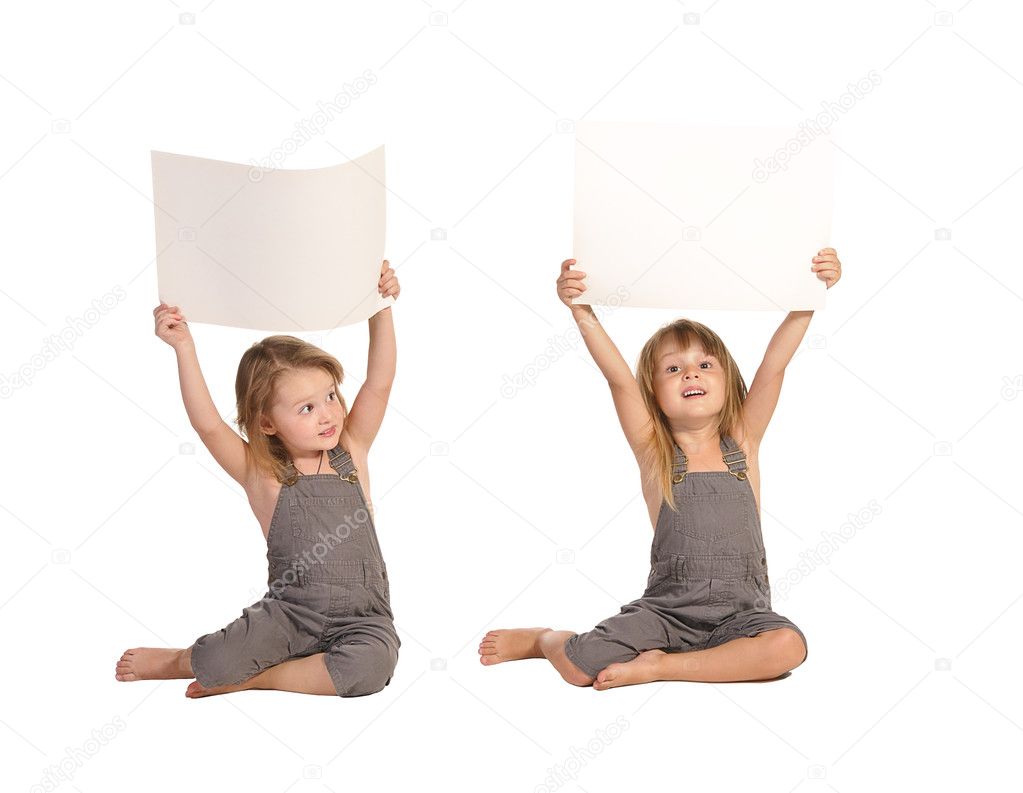 Twins sisters in rompers holding blank paper sheets isolated on