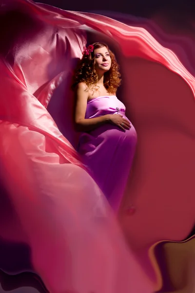 Beautiful pregnant woman in pink and violet dress 3 — Stock Photo, Image