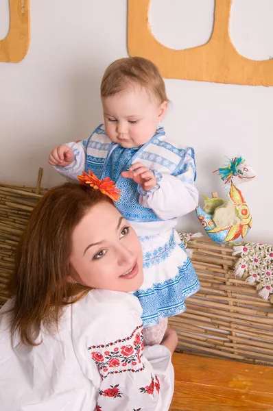 Lovely family in Ukrainian national costumes. Little baby and m — Stock Photo, Image