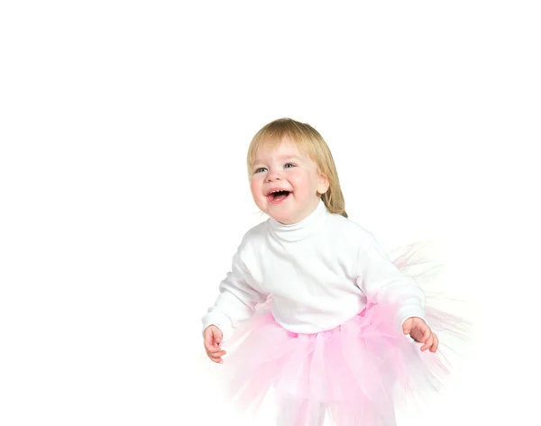 Girl in a pink ballet skirt smiles — Stock Photo, Image
