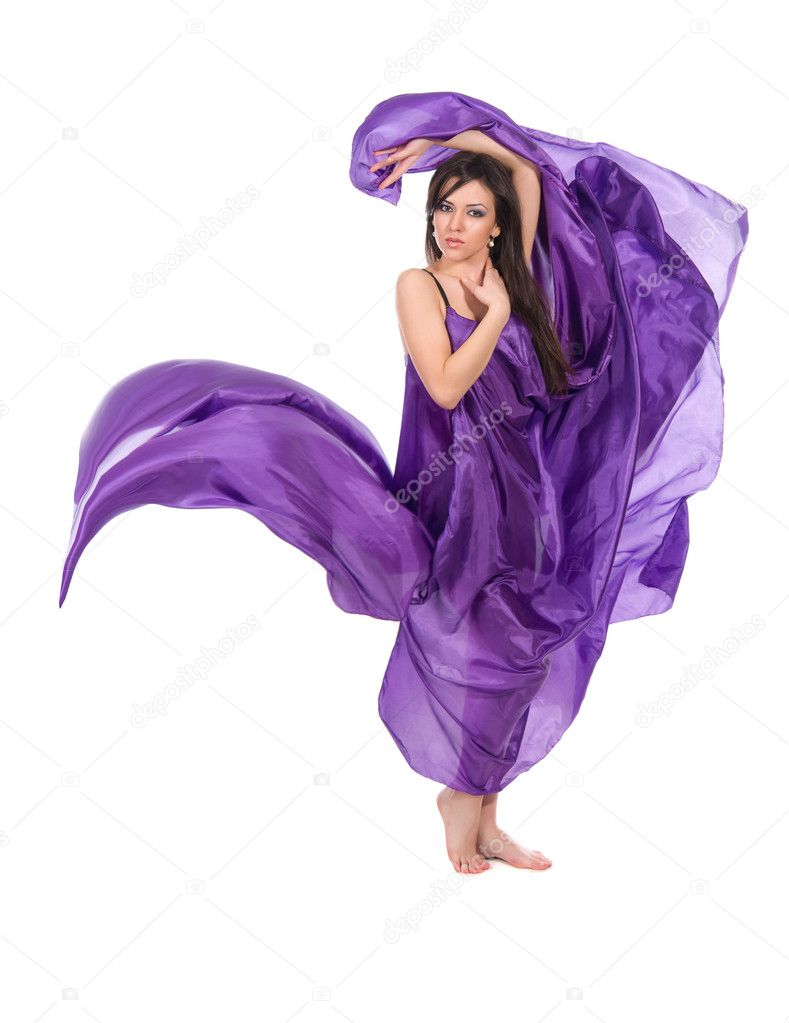 Graceful girl in flying purple silk dress