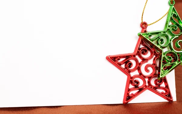 Two Christmas star decorations and card Stock Photo
