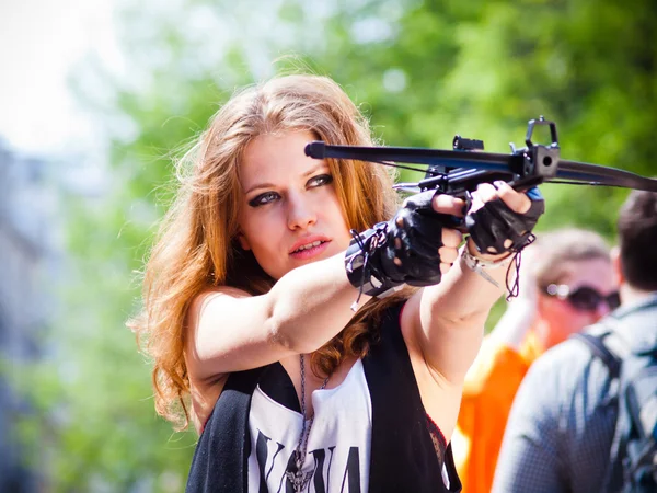 The girl on the street with a crossbow Stock Picture