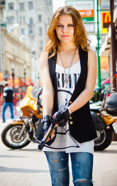 The girl on the street with a crossbow Stock Photo