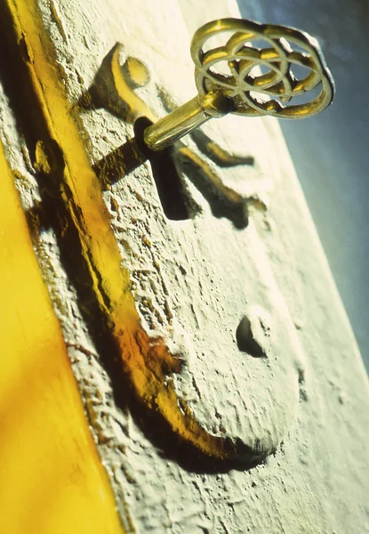 Key în a yellow background — Stok fotoğraf