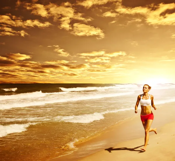 Gesunde Frau läuft am Strand — Stockfoto
