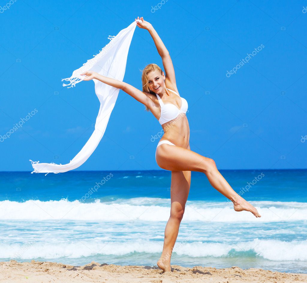 Dancing happy girl on the beach