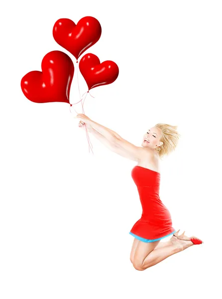 Chica feliz volando, sosteniendo globos rojos del corazón —  Fotos de Stock