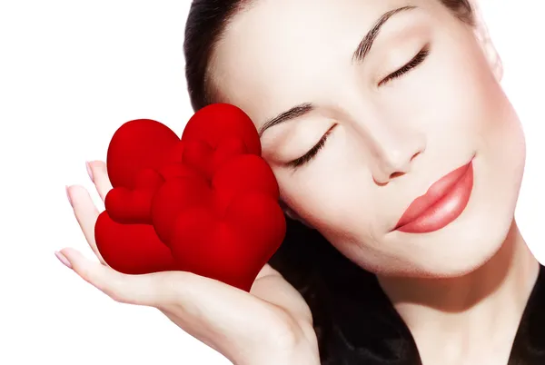 Hermosa mujer sosteniendo muchos corazones rojos — Foto de Stock