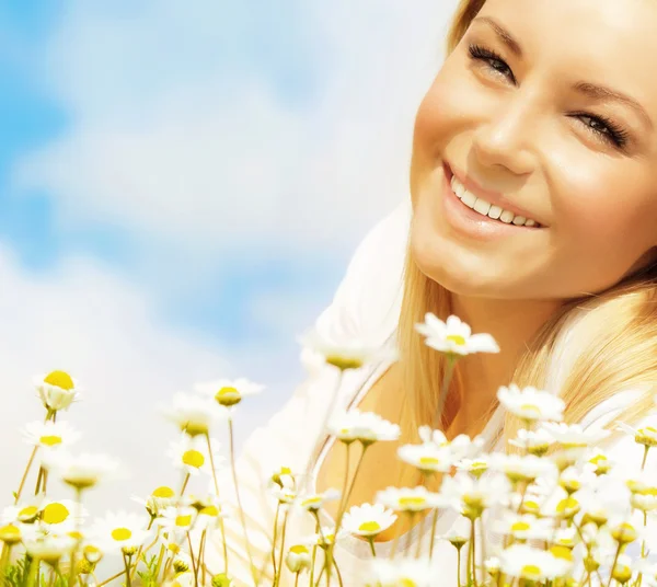 Vacker kvinna njuter av daisy fält och blå himmel — Stockfoto