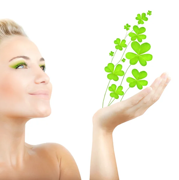 Beautiful woman holding clover leaves — Stock Photo, Image