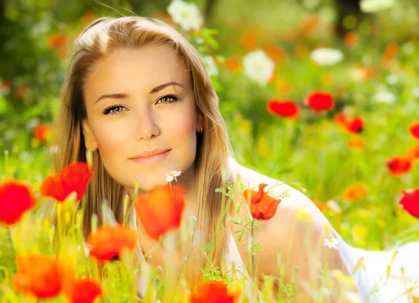 Beautiful female laying on the flower field — Stock Photo, Image