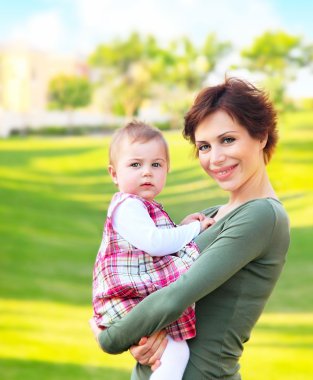 Mother and baby girl outdoor portrait clipart