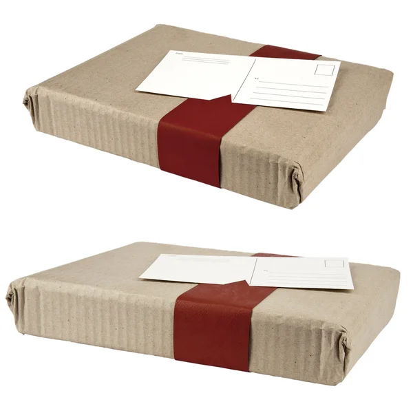 Two wrapped boxes and attached postcard — Stock Photo, Image