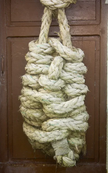 Huge reef knot hanging from a door — Stock Photo, Image