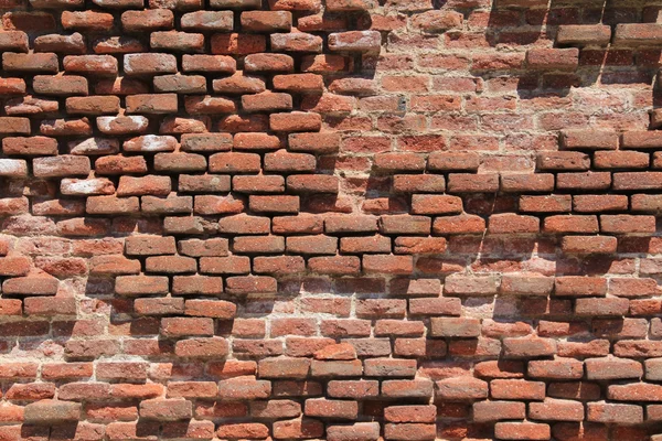 Velha parede de tijolo quebrado — Fotografia de Stock