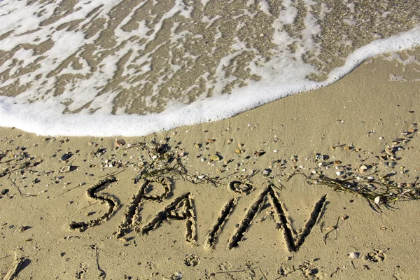 Fale na piaszczystej plaży z Hiszpanii tekst — Zdjęcie stockowe