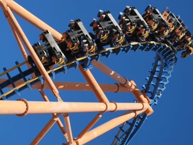 Moving roller coaster with blue sky