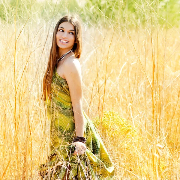 Asian indian woman walking outdoors in golden field — Stock Photo, Image