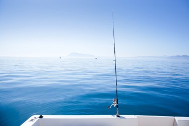 Boat fishing rod in mediterranean blue sea clipart