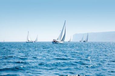 Boats sail regatta with sailboats in mediterranean clipart