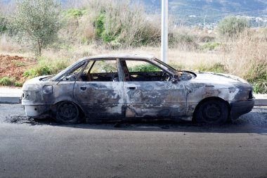 Burned out car in street clipart