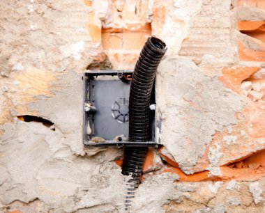 Electrical coil conduit pipe on box embedded in wall