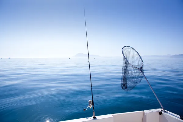 Boat fishing rod and landing net in sea — Stock Photo, Image