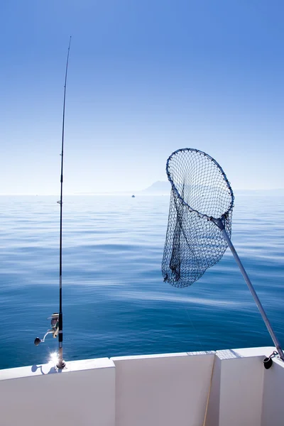 Boat fishing rod and landing net in sea — Zdjęcie stockowe