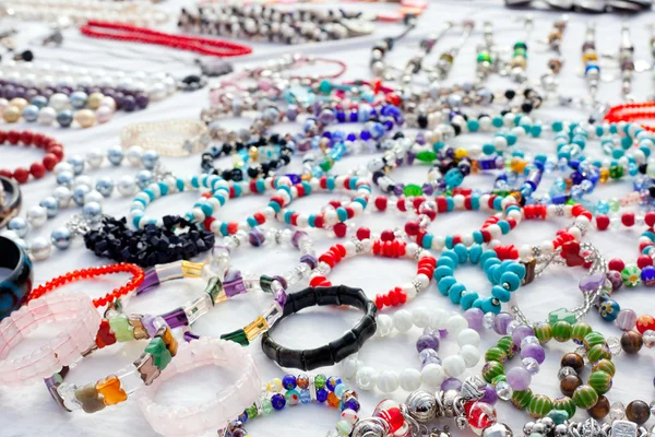 Jewelry in a bargain market spread — Stock Photo, Image