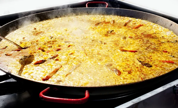 Paella rice from Valencia Spain cooking in big pan — Stock Photo, Image