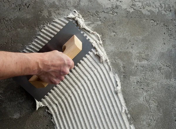 Construction notched trowel with white cement — Stock Photo, Image