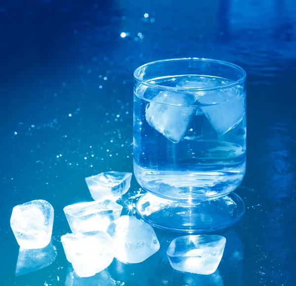 Ice cubes on an iced water surface — Stock Photo, Image
