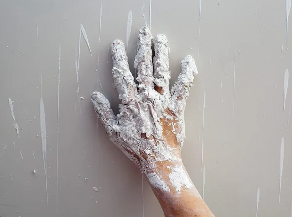 Astist plastering man hand with cracked plaster — Stock Photo, Image