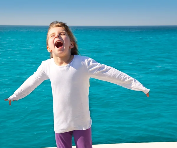 Excited kid girl sailing in a boat open arms — Stock Photo, Image